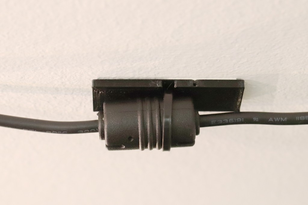 Adhesive strip to cable tie adapter mounted on ceiling